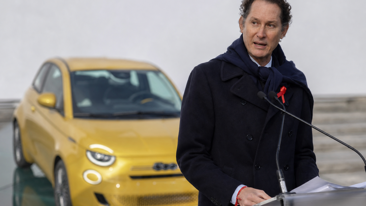 John Elkann at Turin podium near yellow car